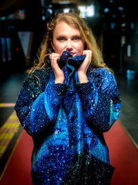 Portrait of beautiful woman standing by camera