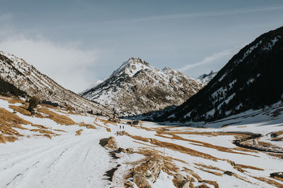 Scenic view of snow covered mountains against sky