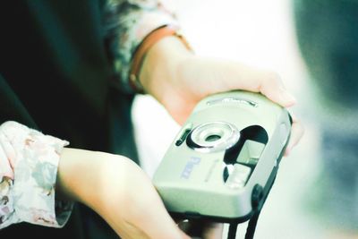 Midsection of woman holding camera