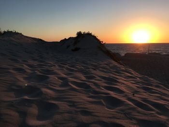 Scenic view of beach against sky during sunset