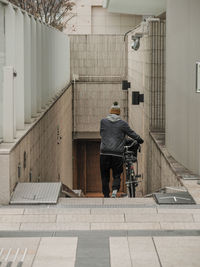 Rear view of man riding bicycle