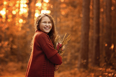 Autumn outdoor portrait of girl walking in forest