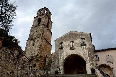 Low angle view of church against cloudy sky