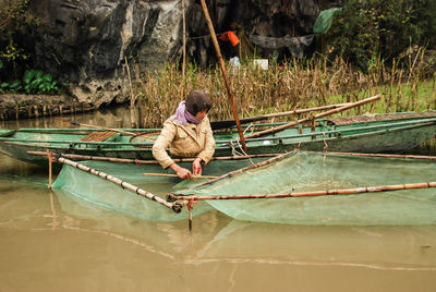 Boy on boat at shore