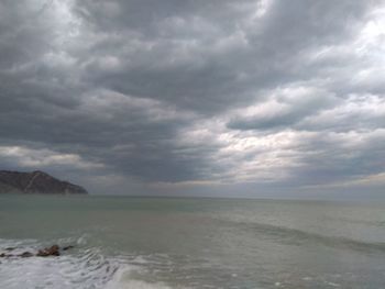 Scenic view of sea against cloudy sky