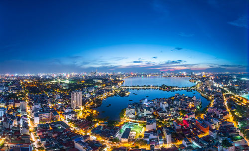 Aerial view of illuminated hanoi cityscape against sky blue hour