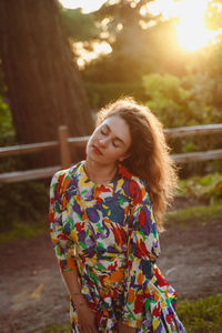 Portrait of young woman standing outdoors
