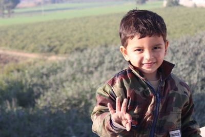 Portrait of boy on field