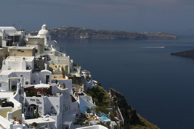 High angle view of townscape by sea against sky