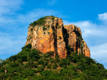 Low angle view of rock formation on mountain against sky