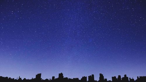 Low angle view of trees against sky at night