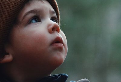 Close-up of cute thoughtful boy looking up