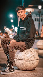 Portrait of young man sitting outdoors