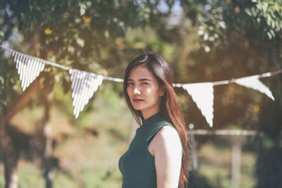 Portrait of woman standing outdoors