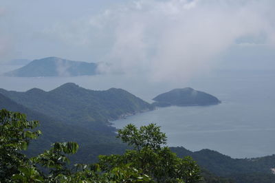 Scenic view of mountains against cloudy sky