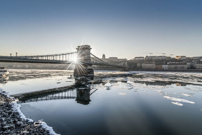 Scenic view of river against sky during winter