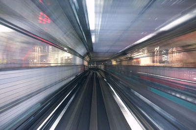 Blurred motion of train at railroad station