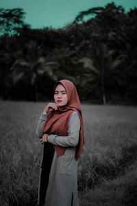Portrait of woman standing on field