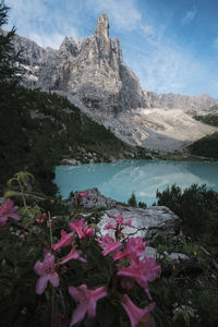 Scenic view of lake by mountain against sky