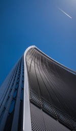 Low angle view of modern building against blue sky