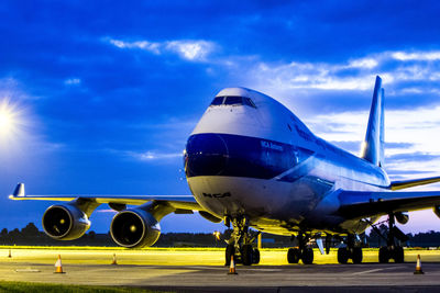 Airplane on runway against sky