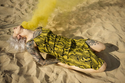High angle view of woman resting on beach