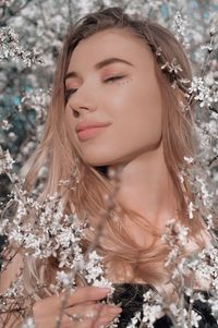 Portrait of a beautiful young woman with eyes closed