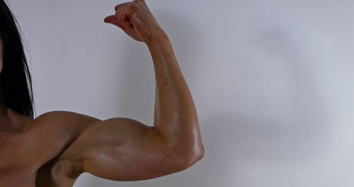 Rear view of woman hand against white background