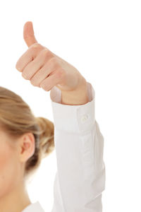 Close-up portrait of woman with hand against white background