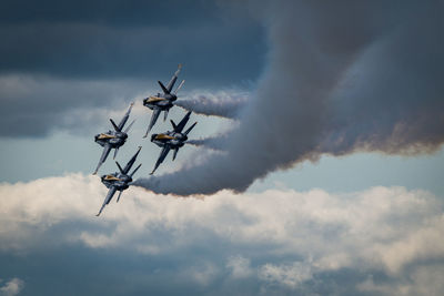 Low angle view of airshow against sky