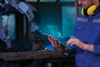 Midsection of man working in workshop