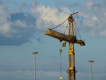 Low angle view of crane against sky