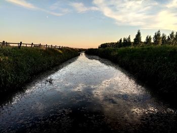 Scenic view of canal against sky