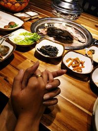 Midsection of woman holding food on table