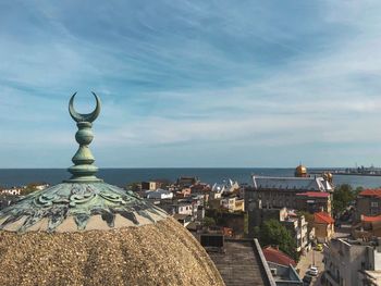 Panoramic view of sea and buildings against sky