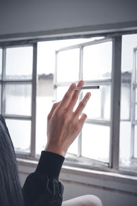 Cropped hand of man using mobile phone
