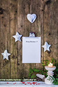 Christmas decorations with clipboard hanging on wooden wall