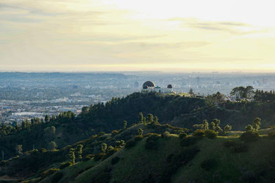 High angle view of plants and buildings against sky during sunset