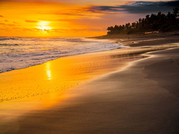 Scenic view of beach against sky during sunset