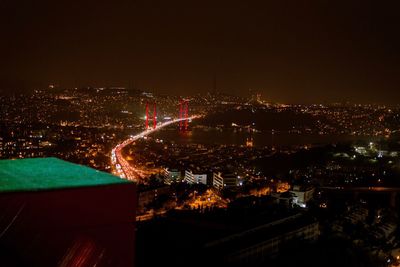 High angle view of illuminated buildings in city at night
