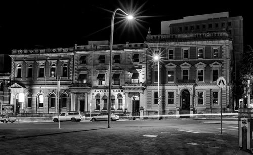 Illuminated building against sky at night