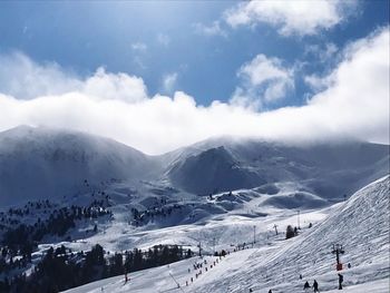 Scenic view of snow covered mountains against sky