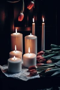 Close-up of lit tea light candles in temple