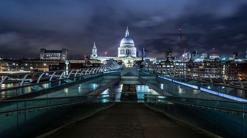 View of illuminated bridge and buildings at night