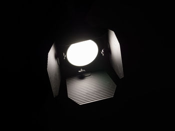 Close-up of illuminated lamp against black background