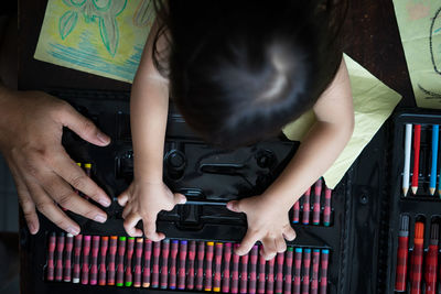 Rear view of child playing on table