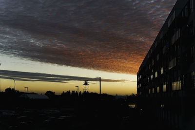 Silhouette city against sky during sunset