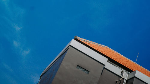 Low angle view of building against blue sky