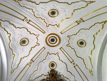 Directly below shot of ornate ceiling of building