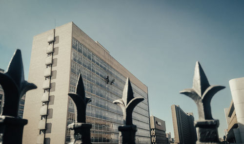 Low angle view of statue against buildings in city